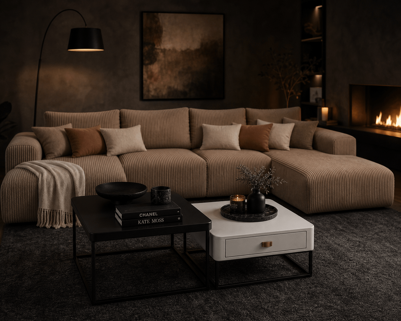 A modern sectional sofa in a warm taupe corduroy fabric, styled in a cozy, dimly lit living room with a fireplace, a black floor lamp, and two coffee tables in the foreground.