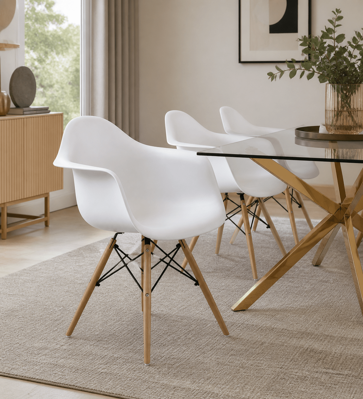 Three modern white molded plastic dining chairs with light wood legs and black cross-members, arranged around a glass-top dining table in a bright, contemporary room.