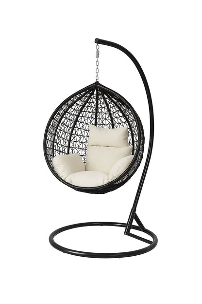 Black wicker hanging chair with white cushions on a white background