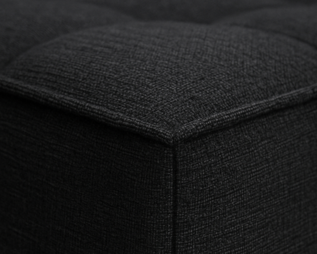 Close-up of a Black upholstered ottoman corner
