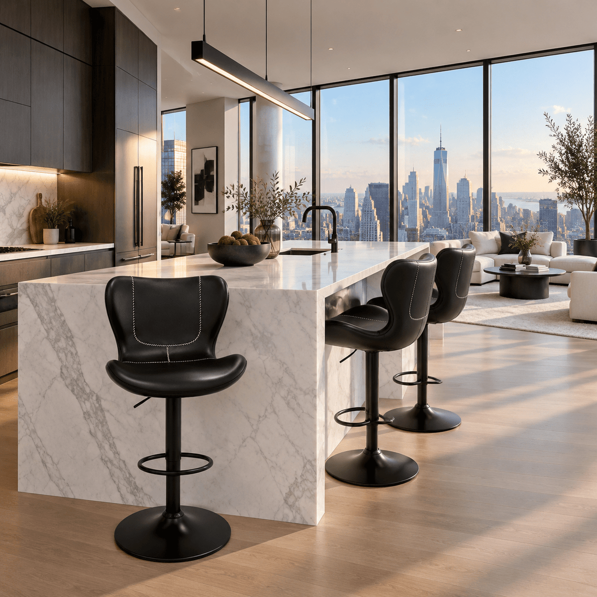 Modern kitchen island with a white marble-look countertop and black bar stools, set in a high-rise apartment with a city skyline view through large floor-to-ceiling windows.