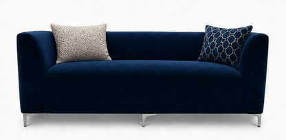 Navy blue sofa with two patterned cushions on a white background
