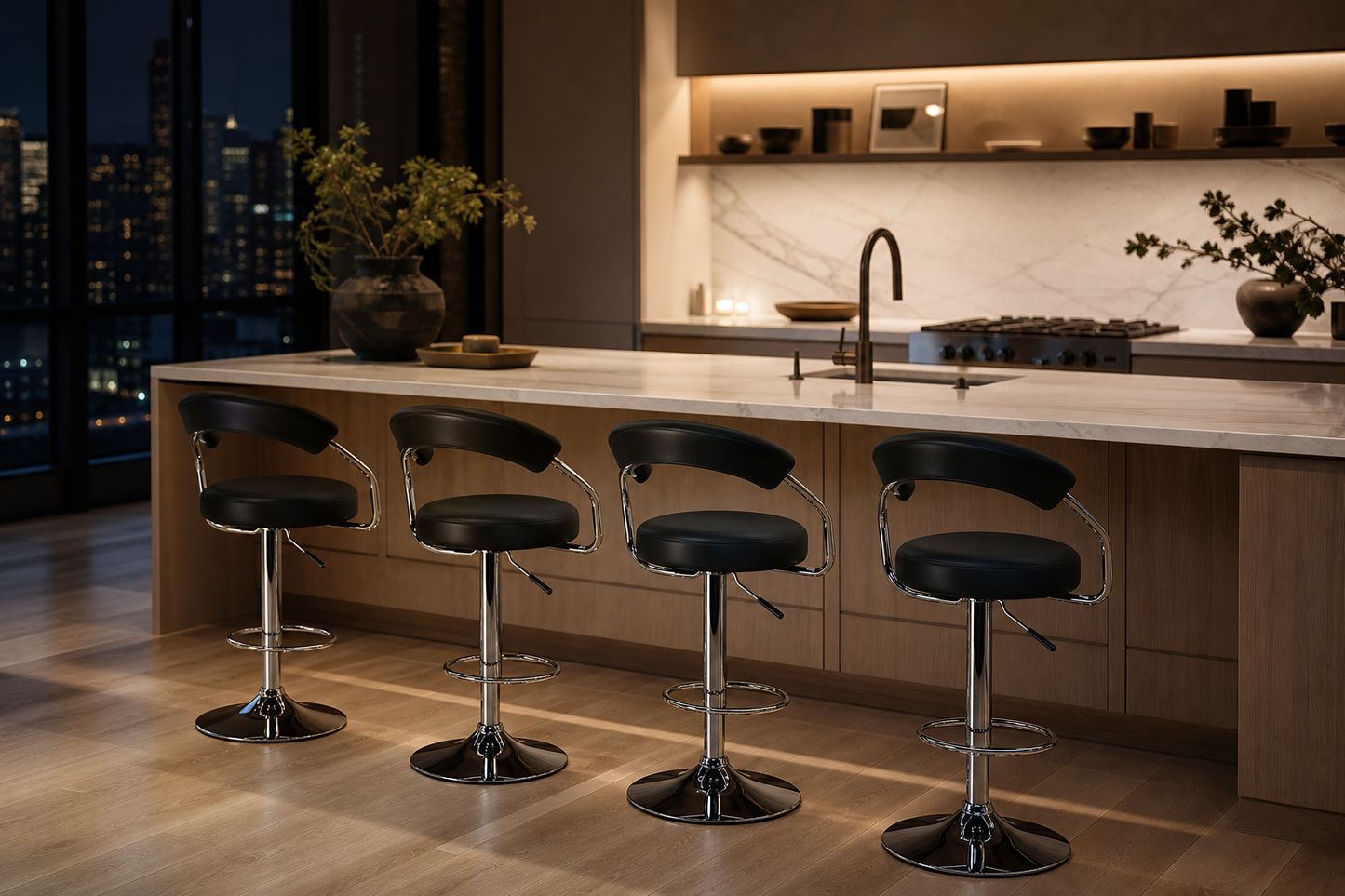 Four modern bar stools with black leather seats and chrome bases arranged in a row in front of a light wood kitchen island with a white marble countertop, set in a contemporary kitchen at night.