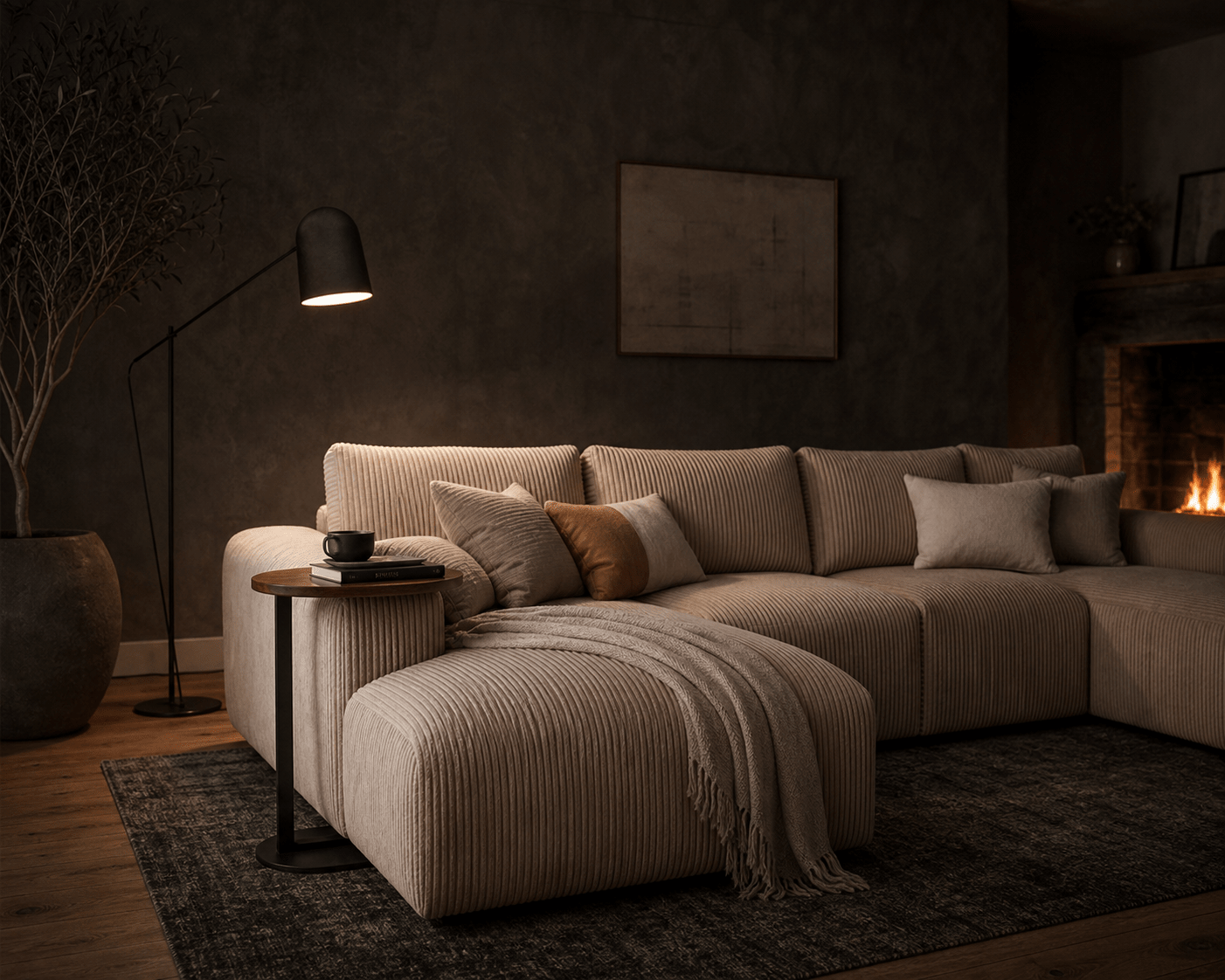 A modern sectional sofa in a warm beige ribbed fabric, styled with matching throw pillows and a fringed throw blanket in a cozy, dimly lit living room with a fireplace and floor lamp.