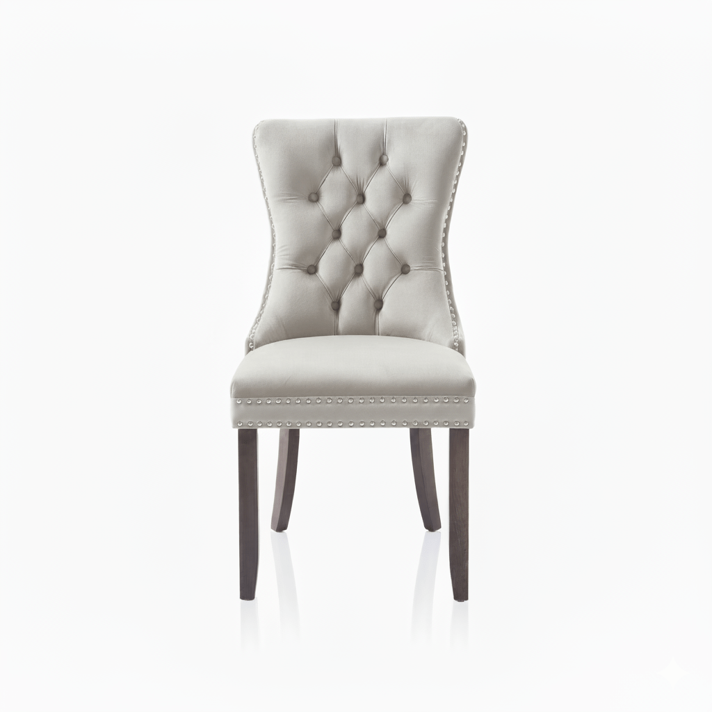 Cream upholstered chair with buttoned backrest and nailhead trim on a white background