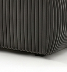 Close-up of a textured dark gray pouf on a white background