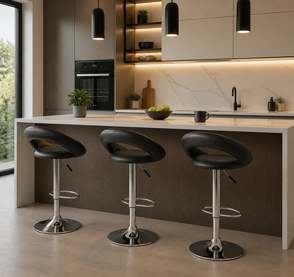 Three black bar stools with chrome bases arranged around a kitchen island in a modern kitchen setting.