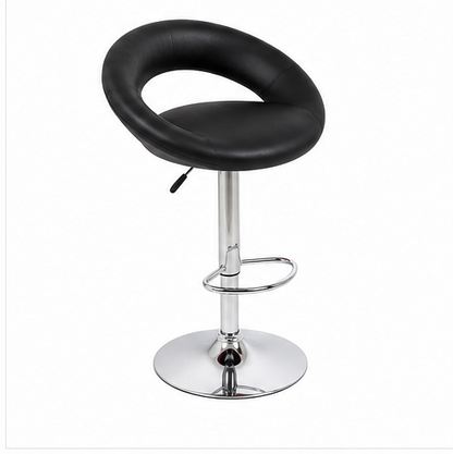 A modern bar stool with a black faux leather seat and a curved backrest, supported by a chrome-plated adjustable pedestal base with a footrest ring.