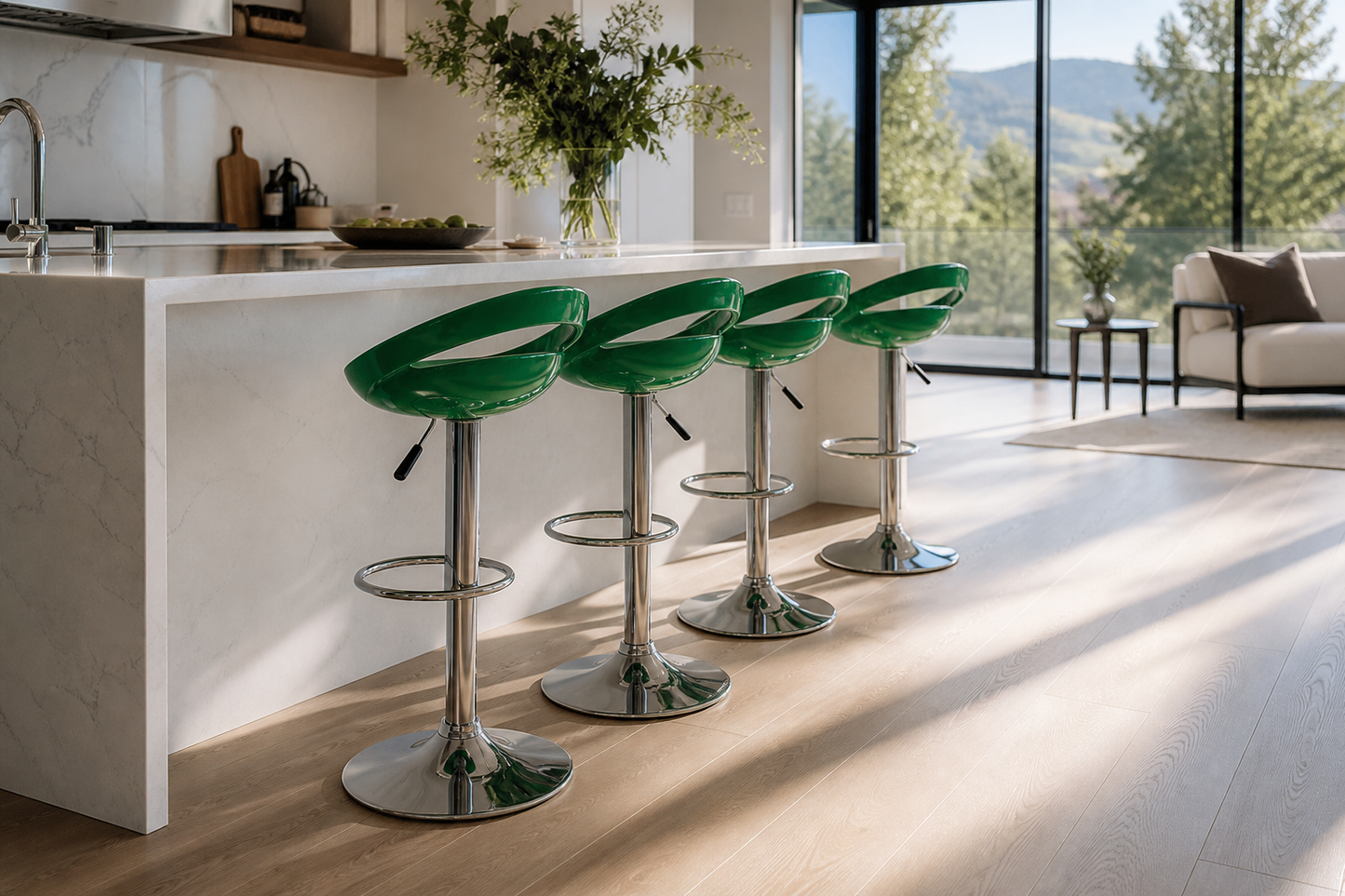 Four green bar stools with chrome pedestal bases lined up along a white kitchen island in a bright, modern kitchen with large windows and a view of trees and mountains.