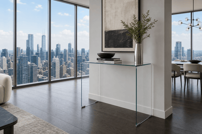 Modern living room with glass console table, city skyline view, and decor items.