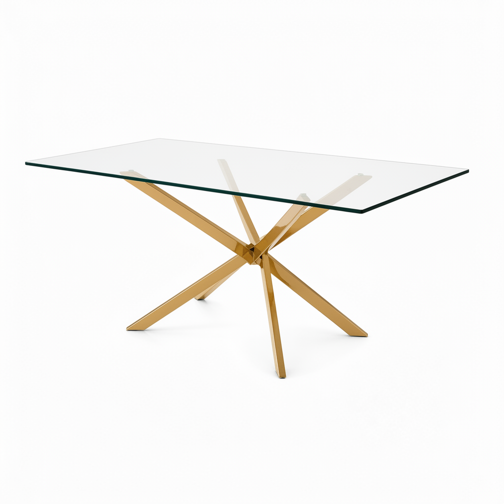 A modern 6 seater gold rectangular dining table with a clear glass top and a polished gold-tone metal X-shaped base, shown on a solid white background.