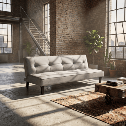 Brown leather sofa in a bright living room with large windows overlooking the ocean.