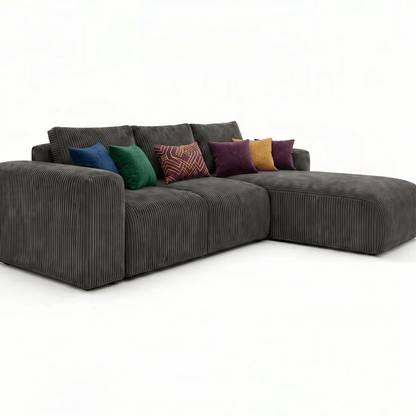 Gray sectional sofa with colorful pillows on a white background