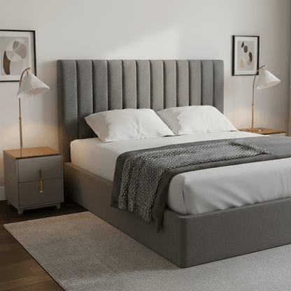 Grey upholstered bed and nightstands with white bedding in a bedroom setting
