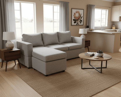 Modern town house  living room with a gray corner sofa, coffee table, and decorative elements. That Couch Place