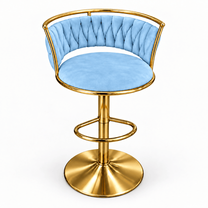 A modern bar stool with a light blue tufted velvet seat and backrest, supported by a polished gold-finished metal frame and circular pedestal base, shown on a plain white background.