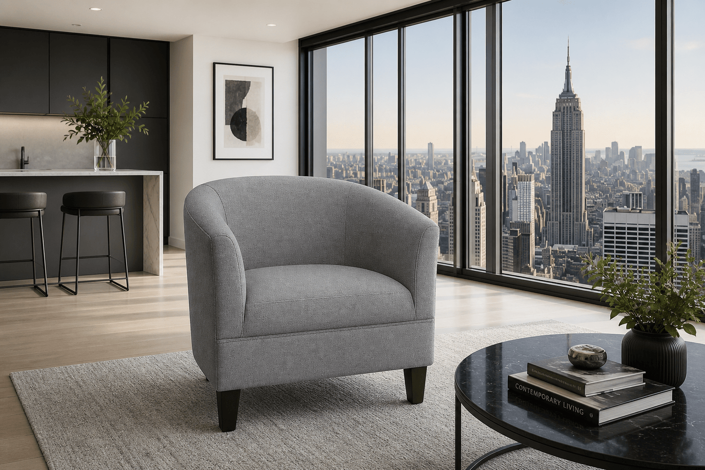 A modern gray upholstered tub chair with dark wooden legs, positioned in a high-rise apartment living room with a city skyline view of the Empire State Building through large floor-to-ceiling windows.