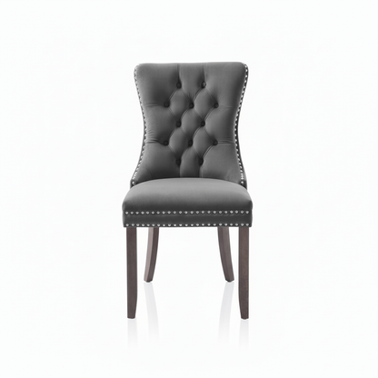 Gray Velvet upholstered chair with silver studded details on a white background