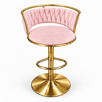 A modern swivel bar stool with a light pink tufted velvet seat and backrest, supported by a polished gold-finished metal frame and circular pedestal base.