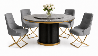 A round dining table set with a gray marble top, black fluted pedestal base with gold trim, and four gray upholstered chairs with gold-tone crossed legs, shown on a white background with a vase of white flowers on top.