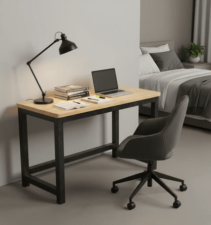 Modern desk with laptop, lamp, and books in a bedroom setting. That Couch Place
