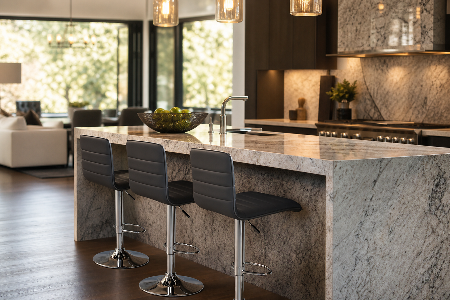 A modern kitchen island with a large gray and white marble countertop and matching marble base, paired with three dark gray bar stools with chrome bases. The kitchen features dark wood cabinetry, a stone backsplash, and pendant lights.