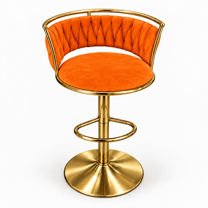An orange velvet swivel bar stool with a polished gold metal frame, curved backrest, and round pedestal base, shown on a plain white background.