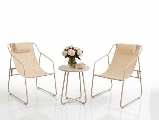 Two beige chairs with a small round table featuring a vase of flowers on a white background