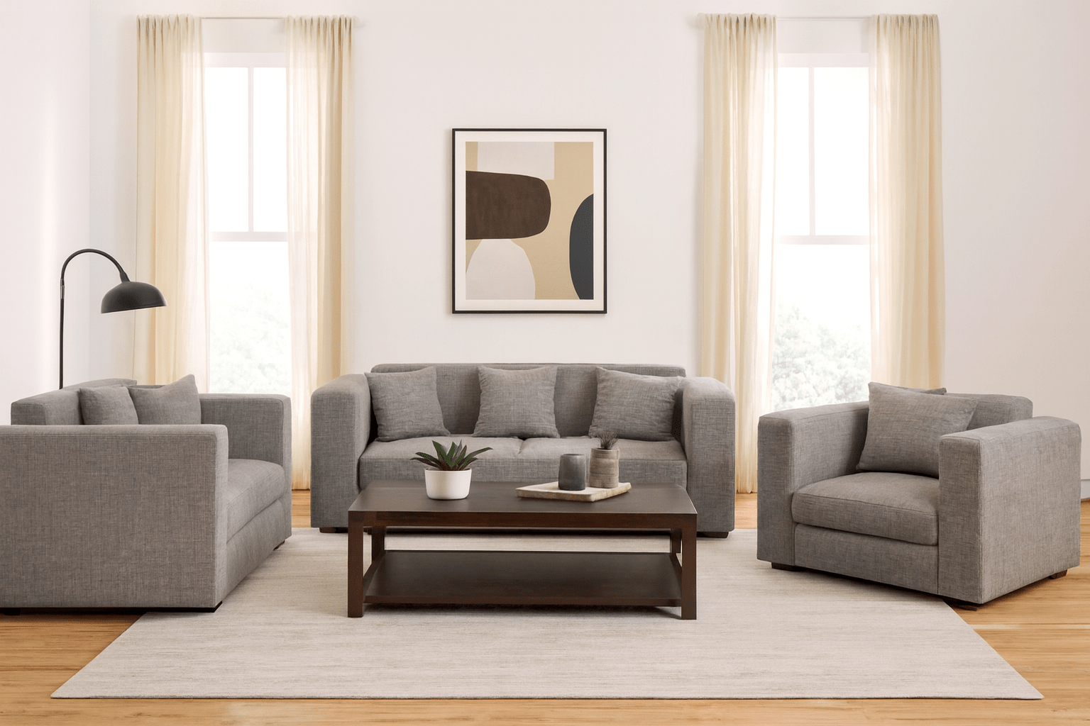 Grey sofa with three cushions on a white background