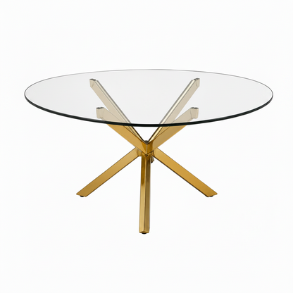 A modern round glass-top dining table with a polished gold-tone metal base featuring an X-shaped central support and four radiating legs, shown on a plain white background.