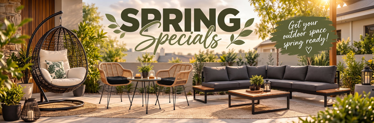 Outdoor patio furniture set displayed in a backyard scene with large 'SPRING Specials' text overlay and promotional badge. The scene includes a dark gray sectional sofa, wicker chairs, a hanging egg chair, and wooden coffee tables on a stone patio with plants and warm evening lighting.