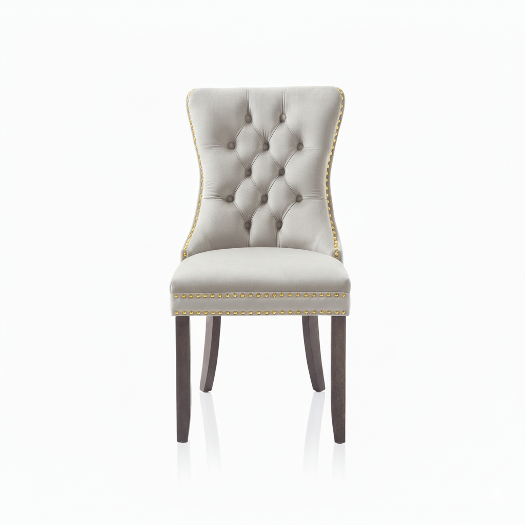 Cream Velvet upholstered chair with tufted backrest, gold studs and wooden legs on a white background 