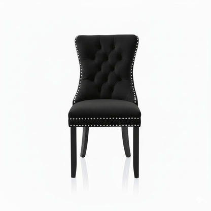 Black upholstered chair with studded details on a white background