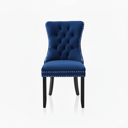 Blue tufted chair with silver studded details on a white background