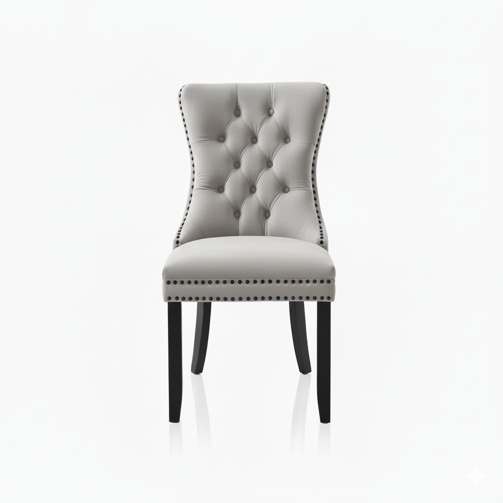 Beige upholstered chair with buttoned backrest and nail head trim on a white background