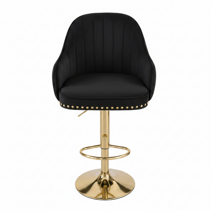 A modern bar stool featuring a deep navy blue velvet upholstered seat and curved backrest with vertical channel tufting, accented with gold nailhead trim. The stool is supported by a polished gold-finished metal swivel base with a circular footrest ring.