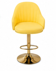 A modern bar stool with a bright yellow tufted upholstered seat and curved backrest, supported by a polished gold-tone metal pedestal base with a footrest ring.