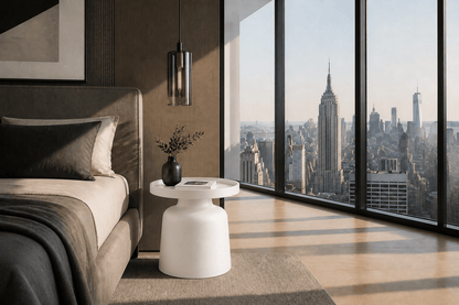 A modern bedroom interior with a bed, white side table, pendant light, and large floor-to-ceiling windows overlooking a city skyline. No person or animal is present, but the real room environment is visible, so this fits Lifestyle rather than Product/Packaging.