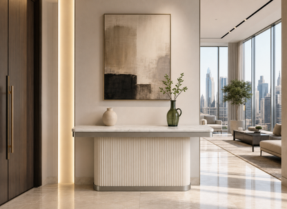 Modern interior with a console table, abstract painting, and cityscape view.