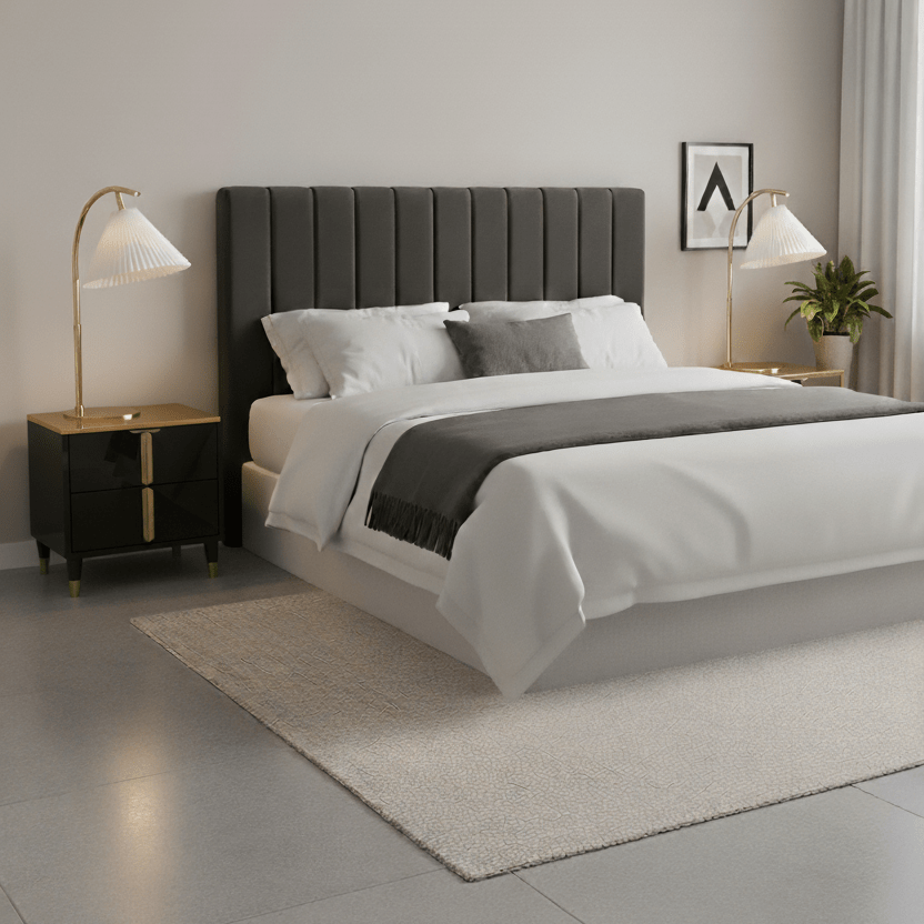 Modern bedroom with a gray upholstered bed, white bedding, black bedside table and two lamps.