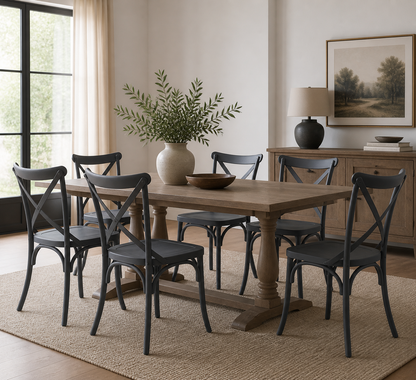 A rustic wooden dining table with six black chairs in a bright, modern dining room setting.